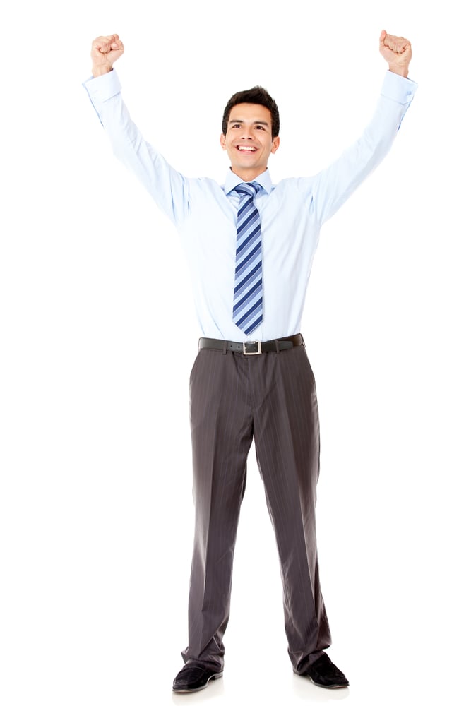 Successful businessman celebrating with arms up - isolated over a white background