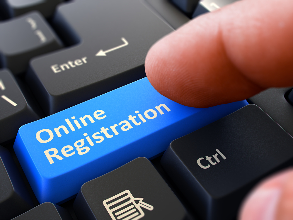 Online Registration - Written on Blue Keyboard Key. Male Hand Presses Button on Black PC Keyboard. Closeup View. Blurred Background.-2